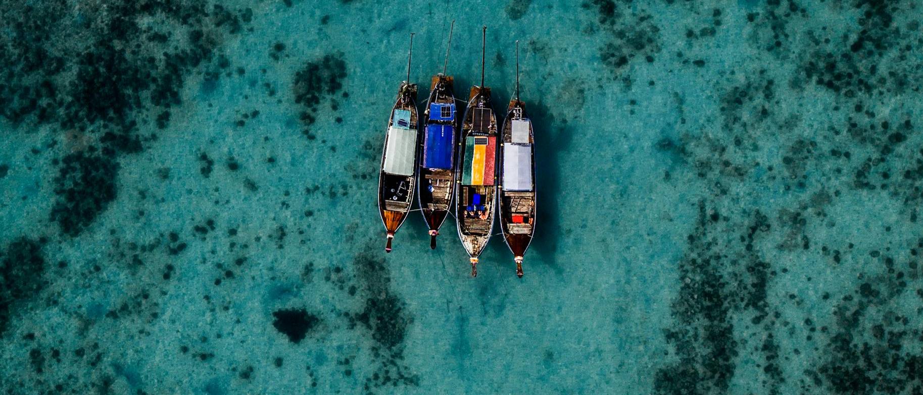 Four boats in the middle of the ocean near Thailand